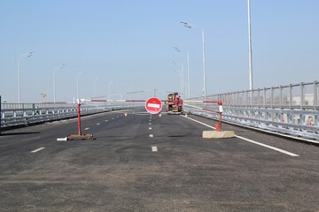 Vehicle access traffic barrier gate with no entry sign. Roadblock in a highway. City road under construction site. Work zone. Road repair and rodework concept. Transport infrastructure development