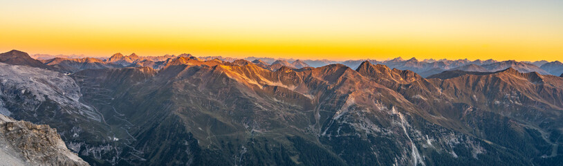 Alpine mountain peaks illuminated by rising sun