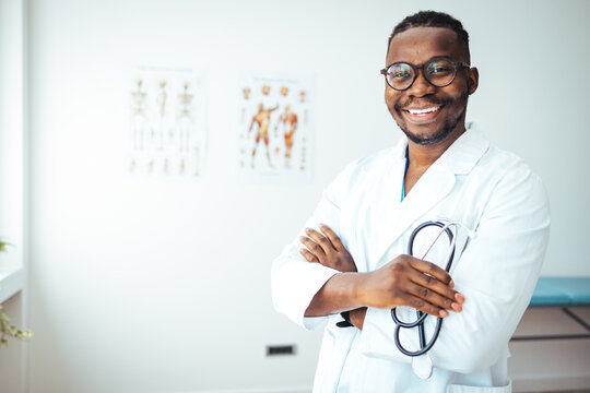 Male african doctor wear medical coat holding stethoscope. Professional medical physician doctor in white uniform gown coat hand holding stethoscope in clinic hospital.