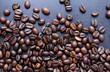 Coffee beans on dark background, close-up still life, International Coffee Day October celebration