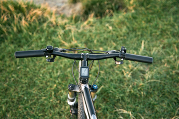 Naklejka na ściany i meble First person view bike handlebar. Outdoor bicycle riding concept.