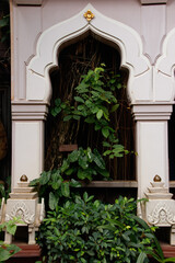 Fototapeta na wymiar Elegant archway or an arcade covered in lush tropical foliage