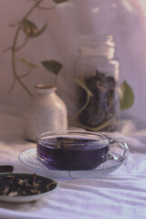 A cup of antioxidant rich herbal blue butterfly pea tea for a relaxing autumn afternoon 