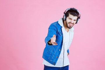 Dj with headphones noticing his fan in the scene