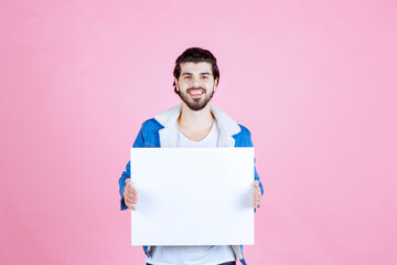 Man holding a square shape thinkboard and enjoying it