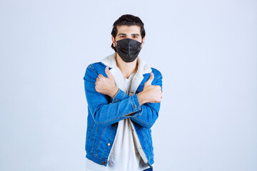 Man in black mask showing enjoyment sign and feeling good