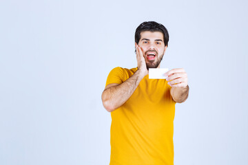 Man receiving the business card of a partner and getting surprized