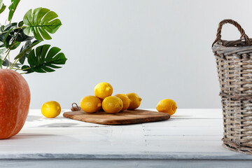 Lemons on a wooden table in a white kitchen interior on a beautiful summer day and free space