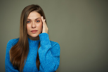 Woman in blue sweater with headache.