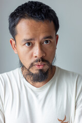 Handsome mustache asian man smiling and laughing