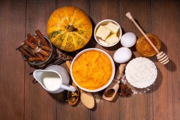 Set of pumpkin pie ingredients - pumpkin puree, spices, cinnamon, dough ingredients, floue, eggs, butter, cream milk, copy space