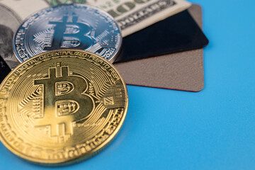 One hundred dollar bill, credit cards and bitcoin