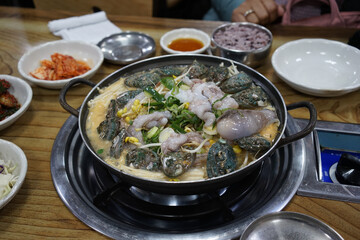 Local Food - Fresh abalone with octopus mix with soup, famous food in Jeju, Korea