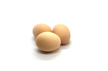 Three chicken eggs on a white background