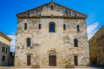 Fototapeta na wymiar View on the 12th century facade of the Saint Pierre de Champagne romanesque church in Ardeche (France)