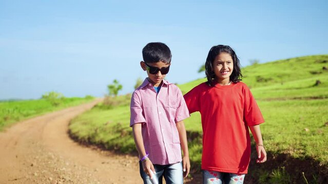 tracking shot of Teenager girl helping blind brother by walking each other at mountain - concept of caregiver,friendship and bonding.