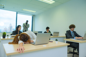 Fototapeta premium Exhausted Asian woman feeling sick, tired, exhuasted while working on table in office.