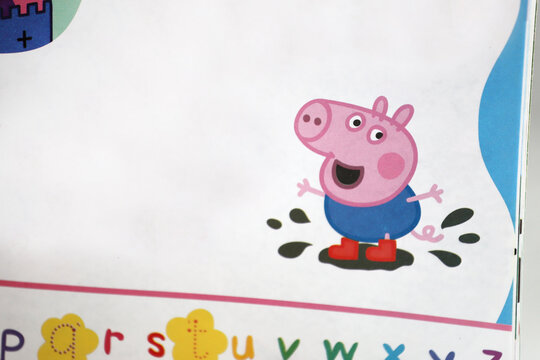George the little brother of Peppa Pig jumping in mud puddles with his rain boots. Magazine for children of the character Peppa Pig.  Cartoon for babies and toddlers. Activity book for kids.
