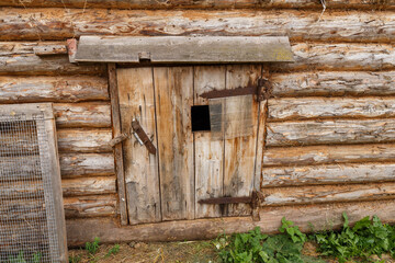 Animal stall. Closed door in a wooden barn. Entrance to the animal shed