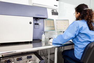 Scientist performing a flow cytometric analysis in the laboratory. Flow cytometer.