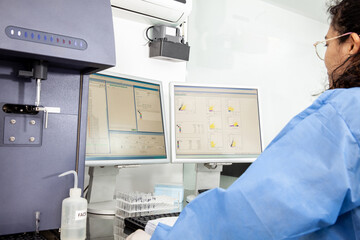 Scientist performing a flow cytometric analysis in the laboratory. Flow cytometer.