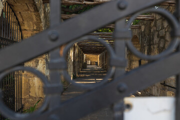 The Alamo side barracks looking through an iron gate