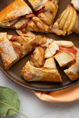 Close up of sliced Autumn apple tart rustic food on plate pie