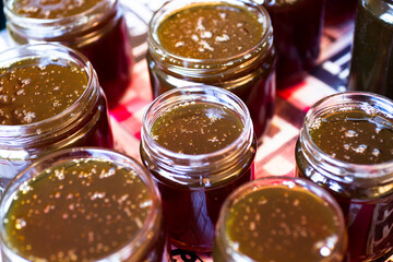 Freshly filled glass jars of honey on a table
