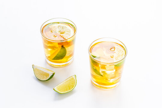 Alcoholic cocktails with oganges and ice in glasses. Alcoholic drinks background