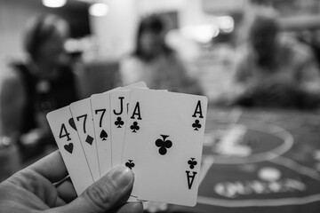 A poker hand during a game in black and white