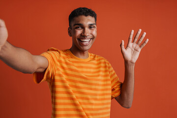 Selfportrait of young handsome smiling happy african man in t-shirt