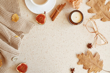 Feminine autumn cozy home lifestyle background - sweater, glasess. Aesthetic coffee time among oak leaves, figs, cinnamon sticks. Copy space.