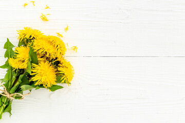 Small posy of yellow dandelions blossoms. Summer floral background