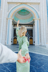 Happy tourist lover couple takes selfie photo against mosque of NurSultan Astana Kazakhstan city...