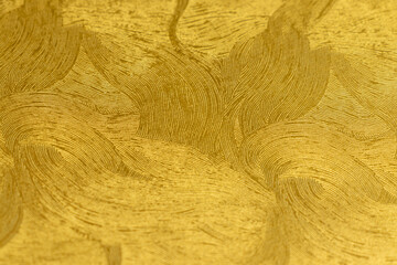 滑らかな曲線模様のある金色の紙
