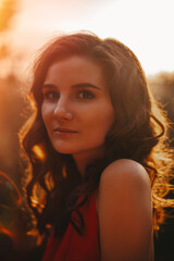 Beautiful woman in red dress sunset portrait