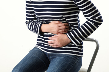 young woman suffering from stomach pain,close-up. food poisoning,cramps, isolated