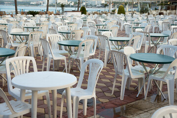 Empty summer resort because of pandemic. Plastic chairs and tables