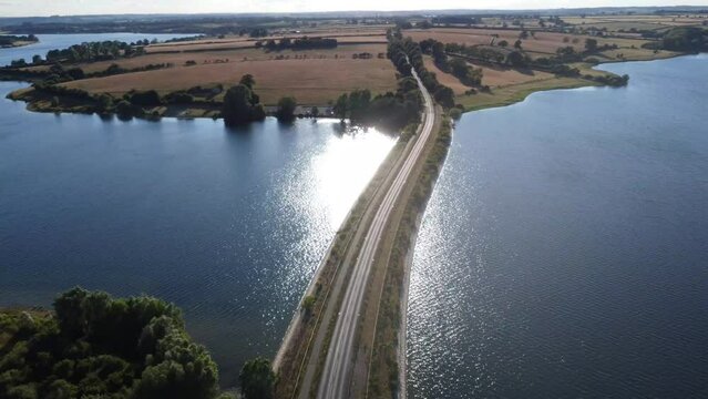Aerial footage of the road over Pitsford Reservoir Causeway in Northamptonshire