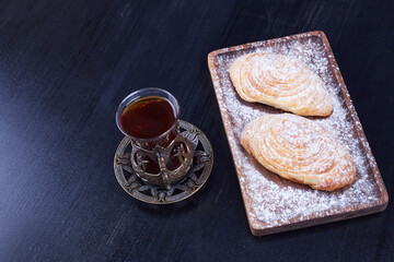 Caucasian traditional pastries with a glass of tea