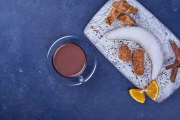 Crispy fried cookies with a cup of hot chocolate, top view