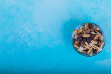 Mushroom shape cookies in a glass bowl on the right