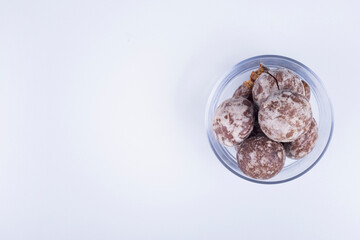Cocoa gingerbreads in a glass cup on white background in the right side