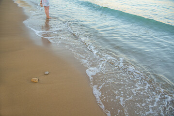 Beach background.Sand and turquoise foamy sea water