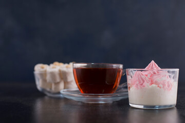 A cup of tea with turkish lokum and marshmallows, angle view