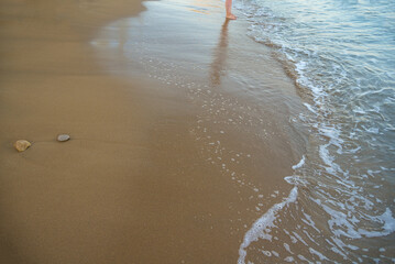 Beach background.Sand and turquoise foamy sea water