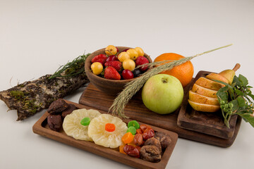 Berries, fruit mix and herbs in a wooden platter