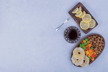 Snack and sweet board served with a glass of tea, top view