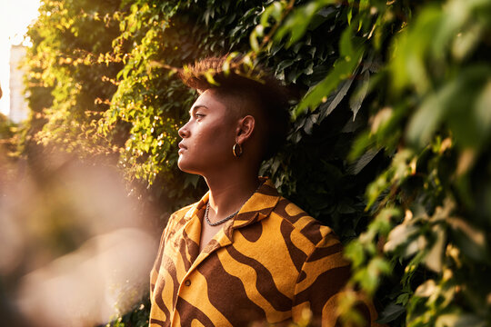Sensual non binary guy in garden