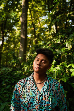 Asian non binary person enjoying sunlight